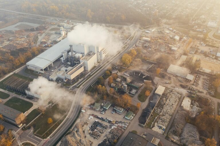 Aerial view showcasing an industrial complex in Poznań, Poland, emitting smoke and steam by pexel