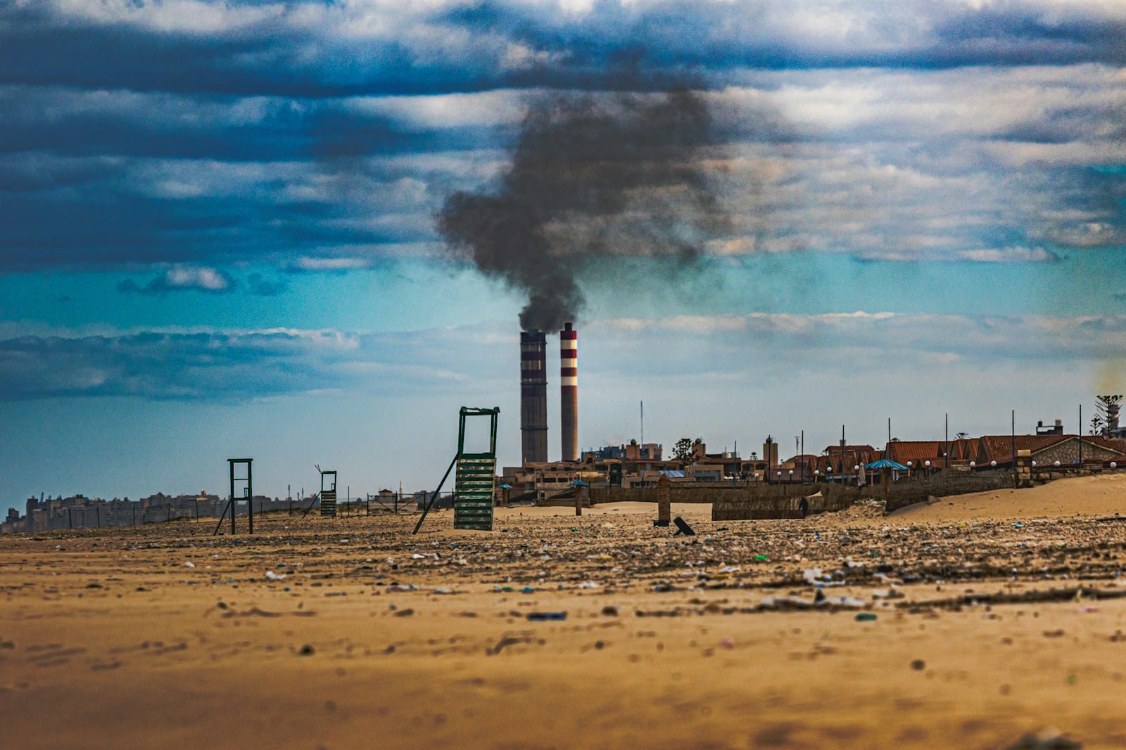 a factory with smoke coming out of it's stacks. carbon pricing.