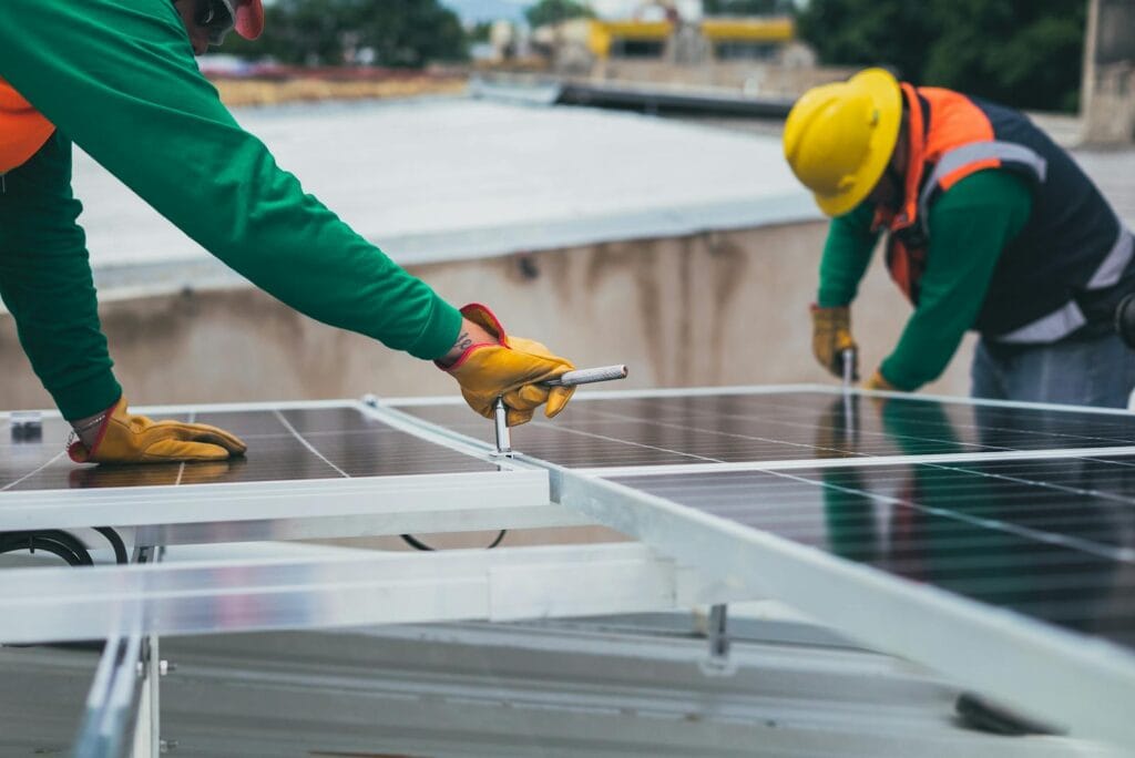 Workers secure solar panels on a rooftop, advancing renewable energy. solar energy.