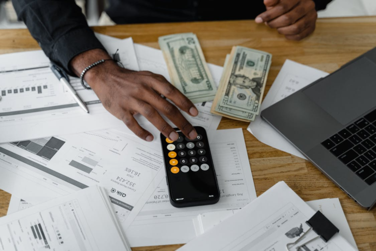 Financial data calculations and business reporting using a calculator and documents as part of sustainability report analysis and ESG performance evaluation